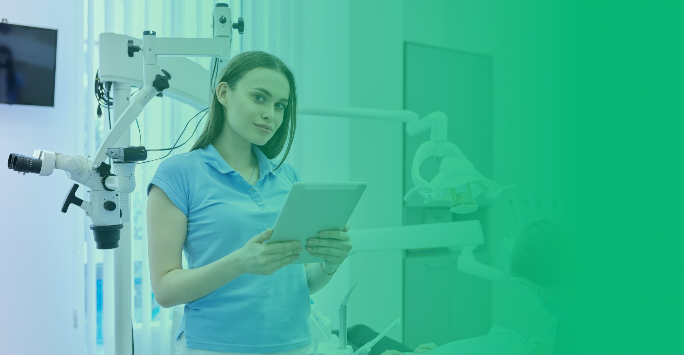 young woman in dentist office looking at a tablet